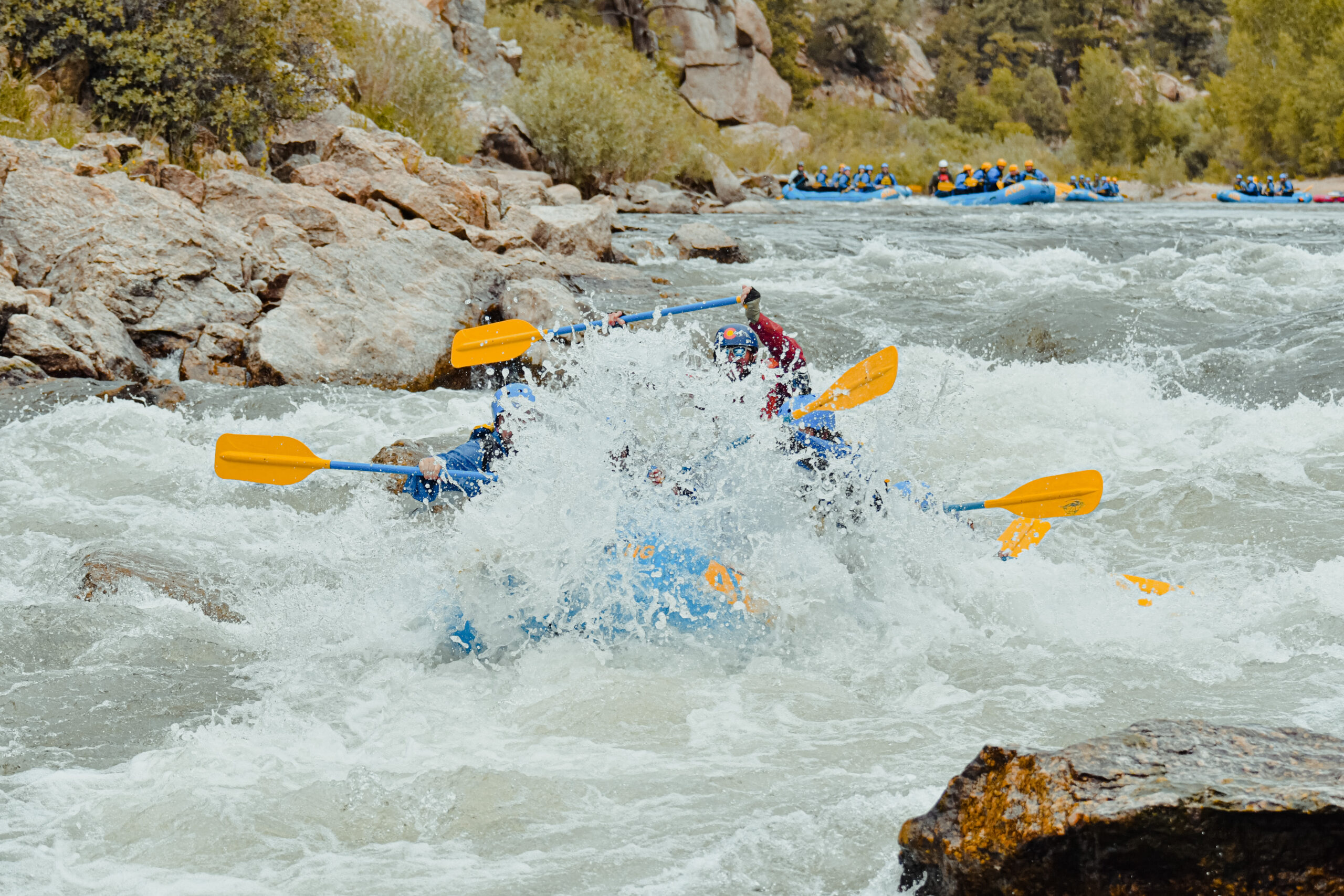 raft submerged in whitewater