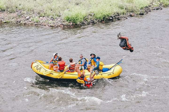 person flipping from raft