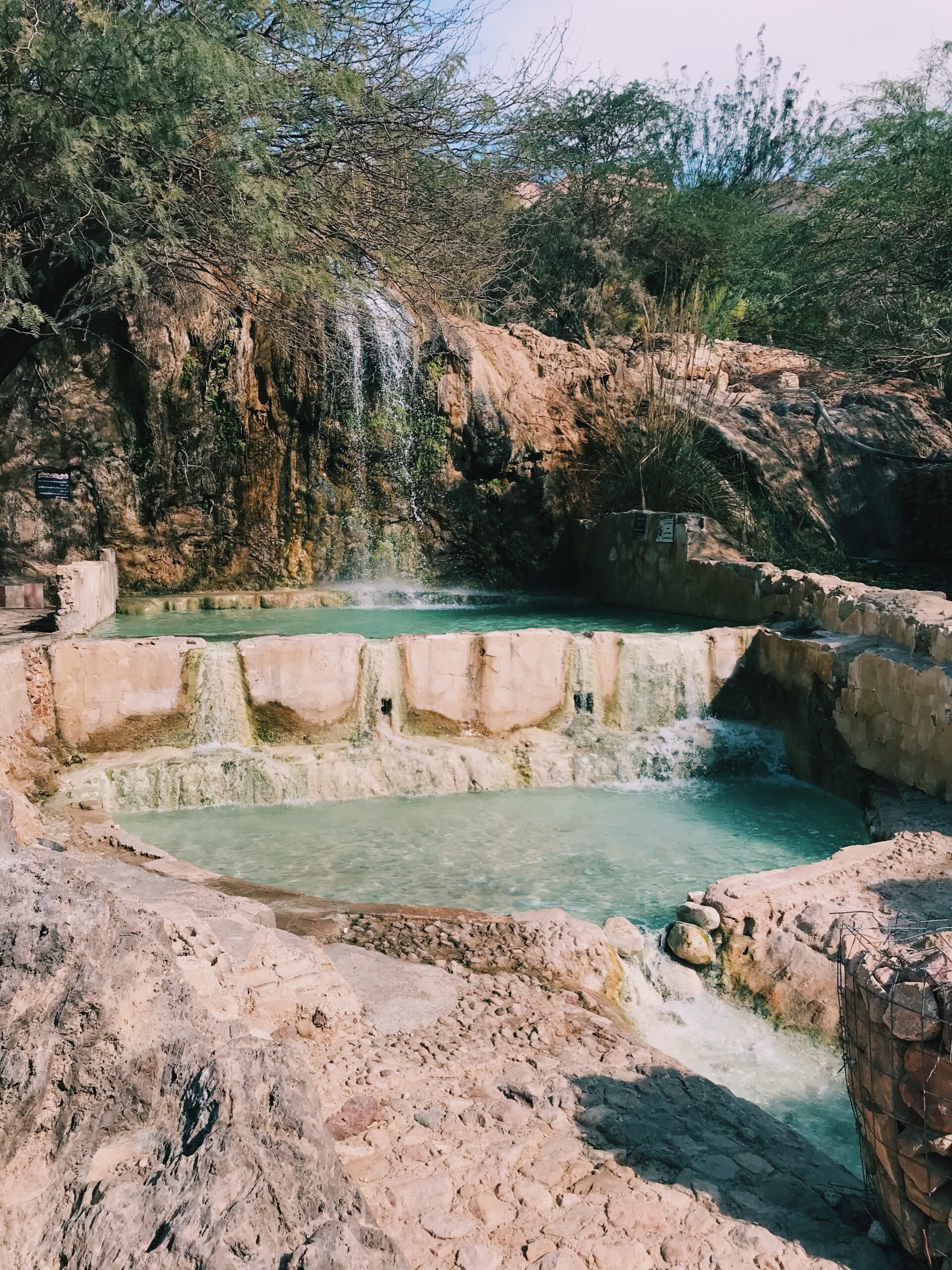 waterfall flowing into hot springs