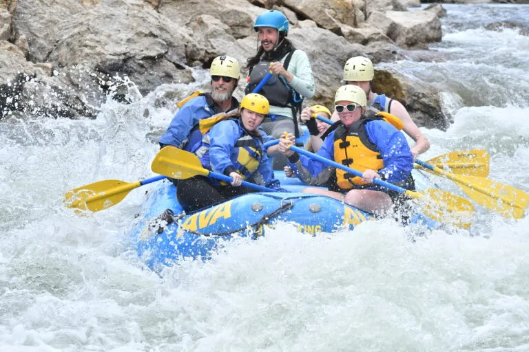 group paddling into more intense whitewater