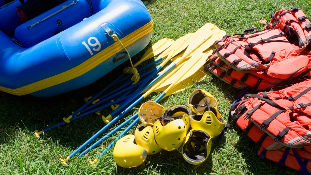Raft and equipment, including safety helmets and lifejackets.