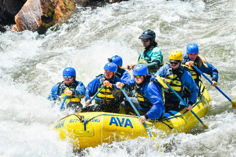 group paddling into oncoming waves