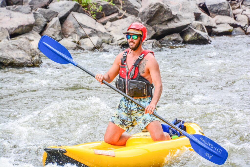 man sitting on inflatable kayak