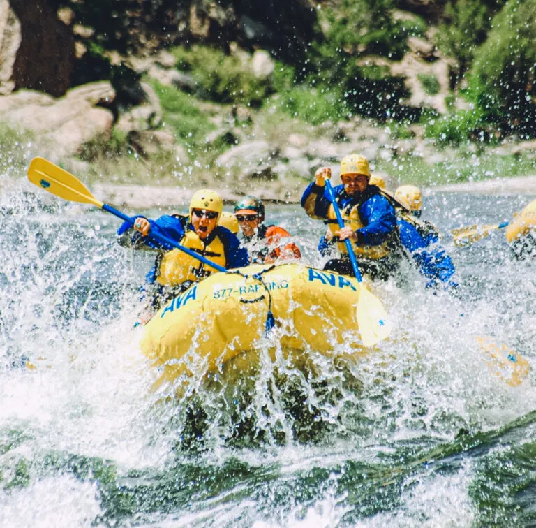 Rafters navigating intense whitewater and spray.