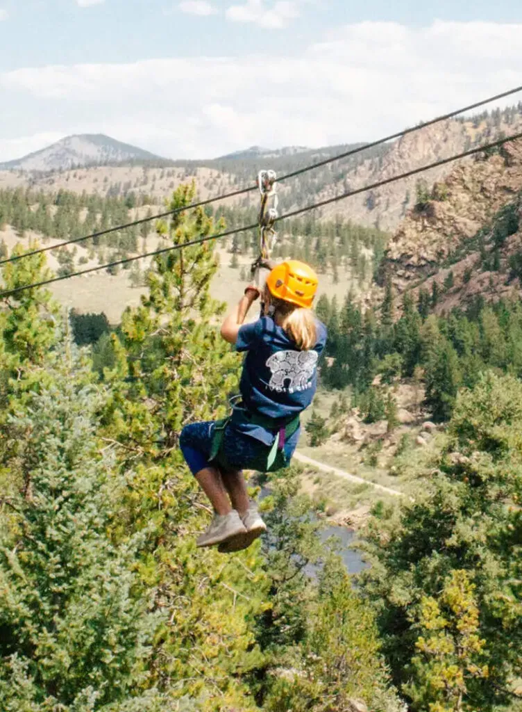 Woman ziplining in the Colorado mountains.