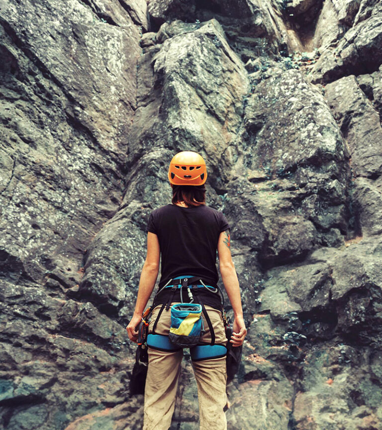 Woman preparing to begin her rock climbing adventure.