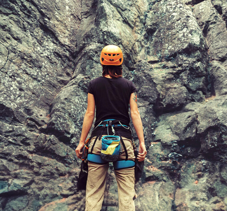 Woman preparing to begin her rock climbing adventure.