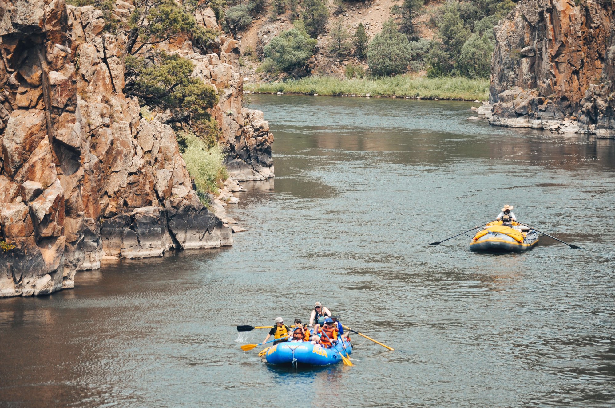 Two rafts floating down the Colorado River in the summer