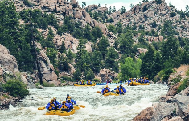 A group of whitewater rafts floating down the Arkansas River in Colorado