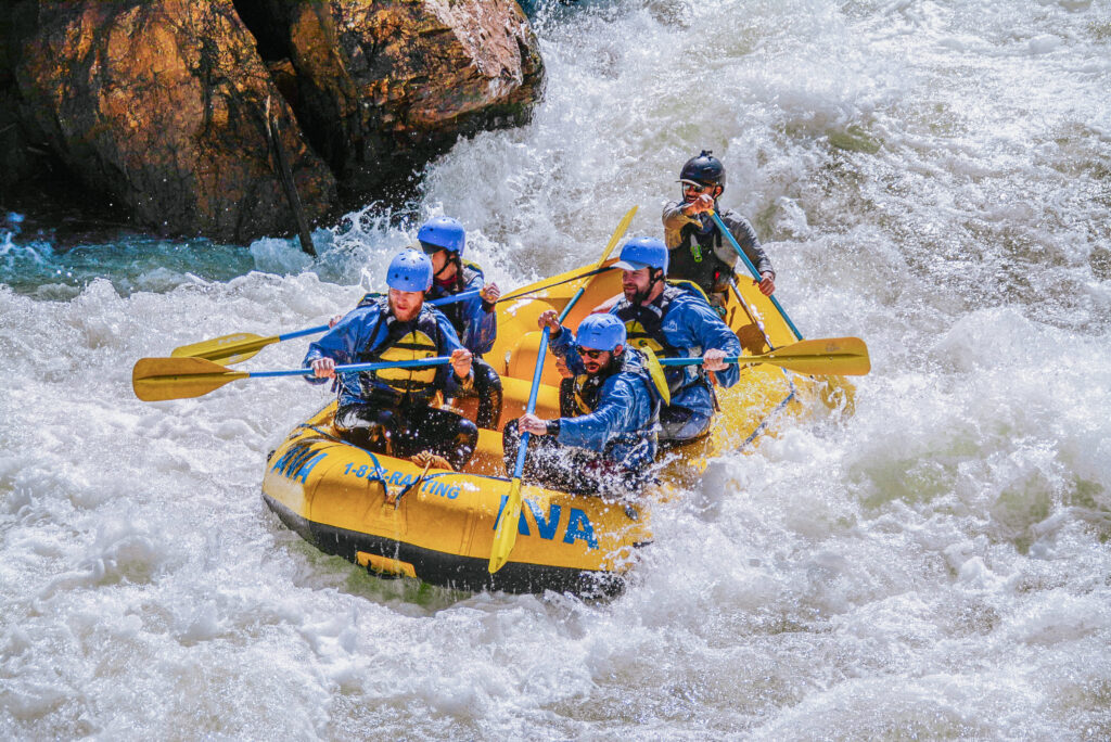 group paddling through splashier rapids