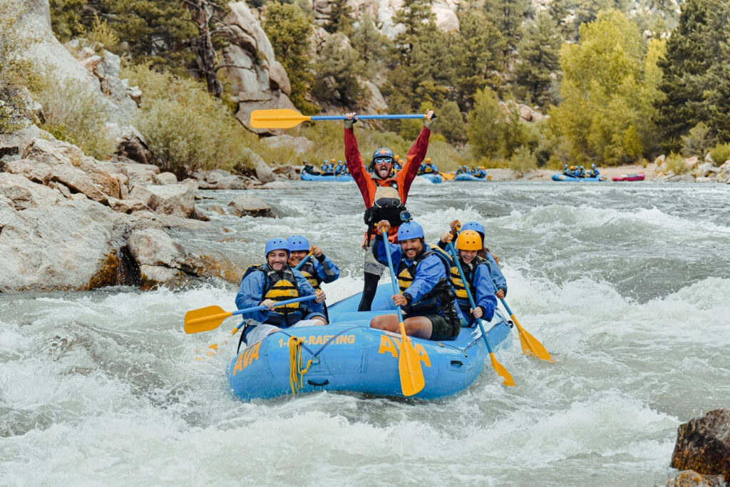 Rafting group celebrating after successfully navigating a difficult stretch of river.