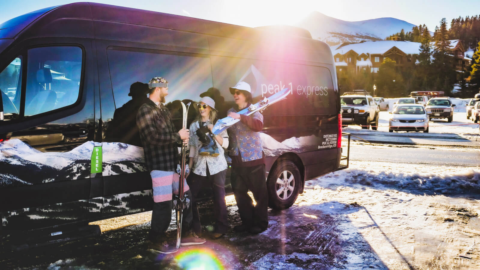 Spring skiers talking beside a peak 1 express shuttle