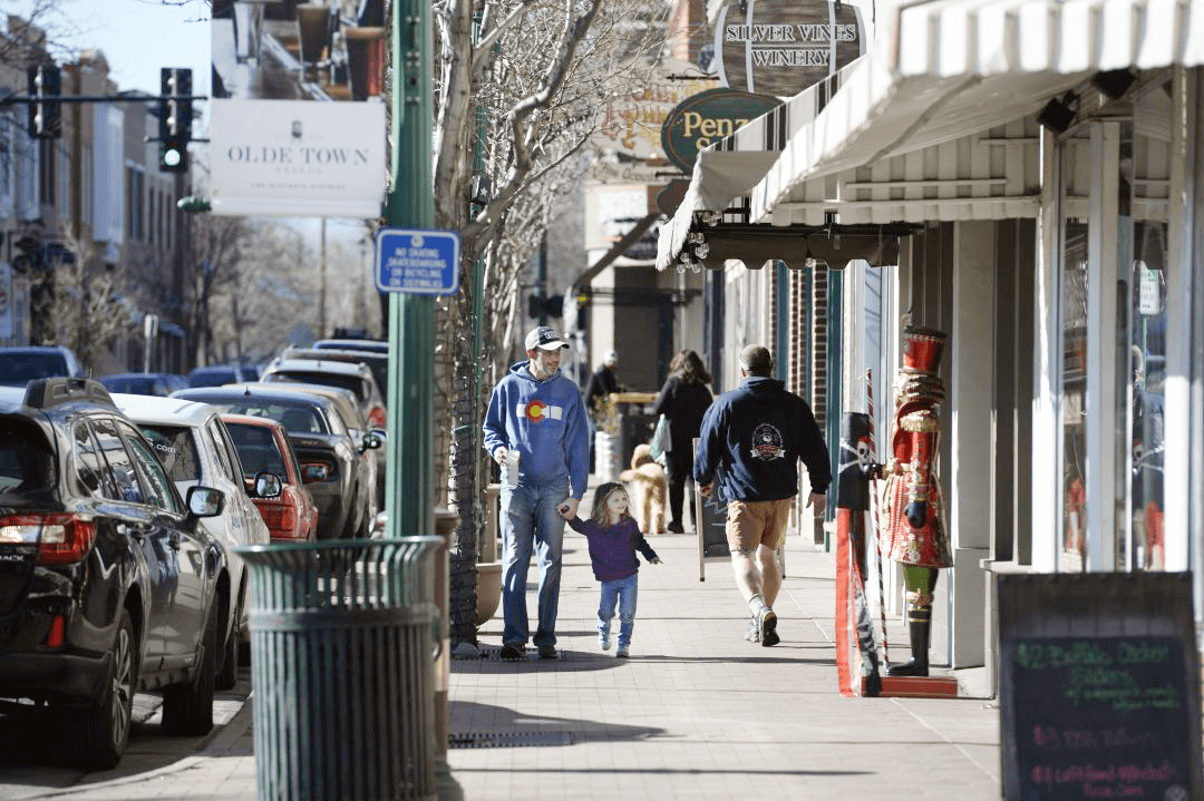 Man and daughter walking in downtown Arvada, Colorado. 