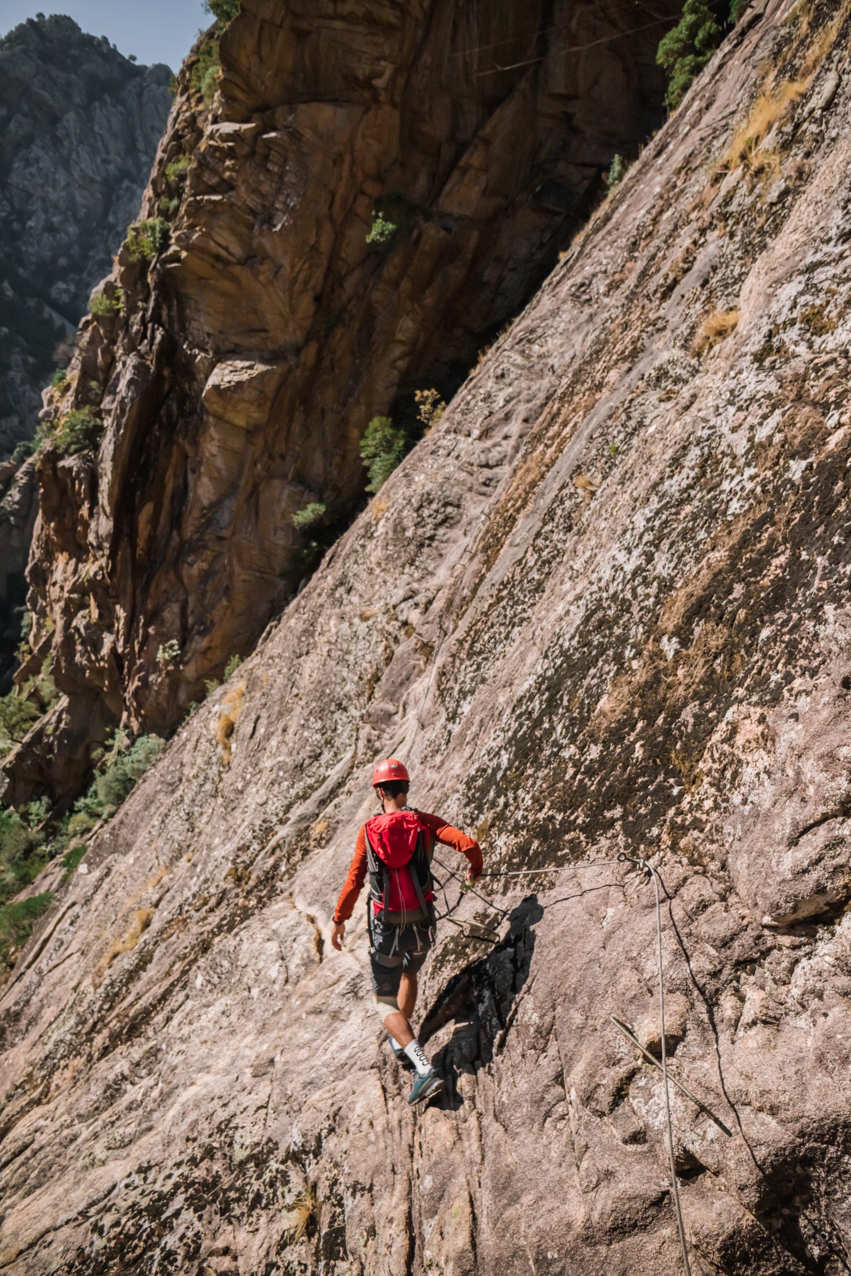 Man crossing Via Ferrata using hand holds