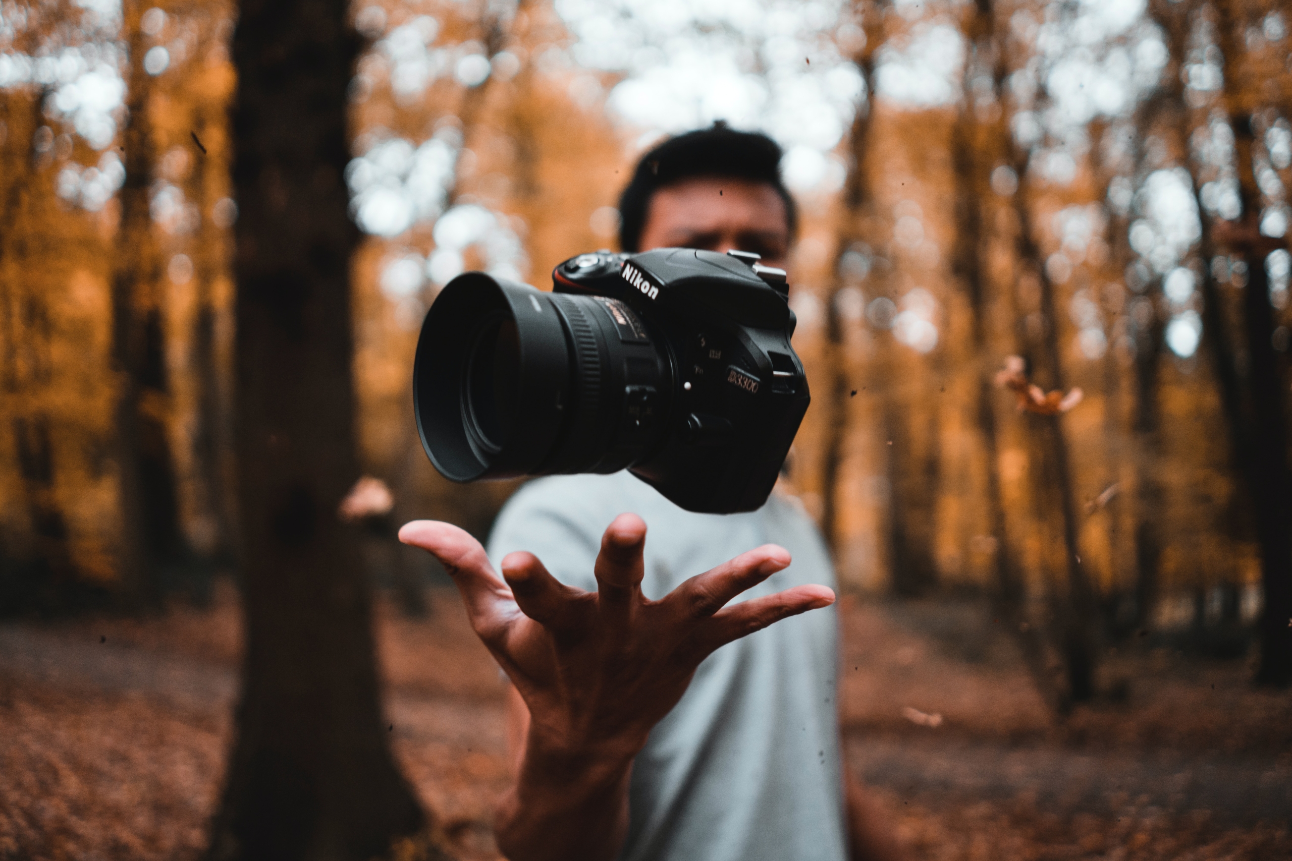 man holding camera in woods