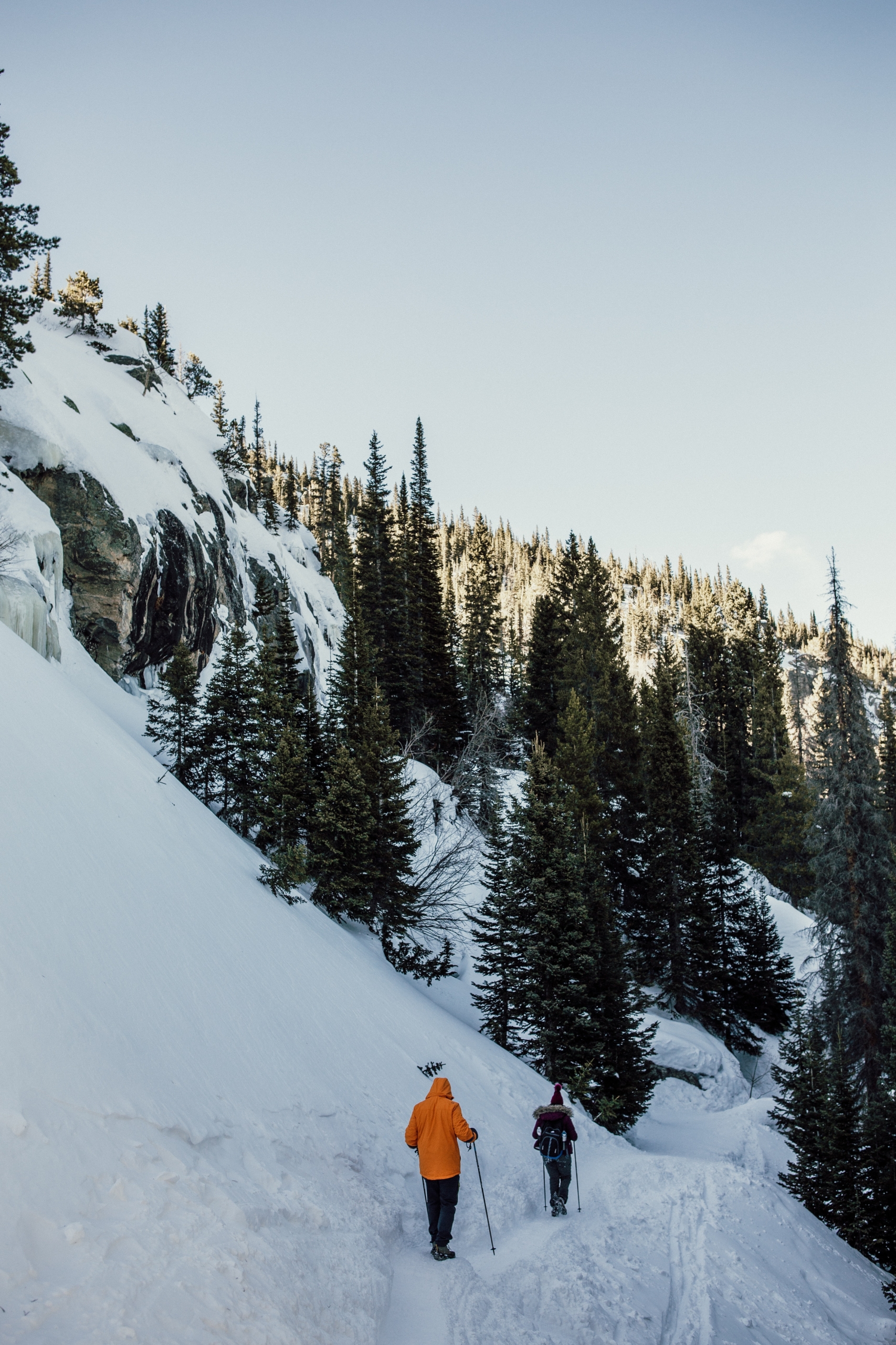 two people hiking through snowy mountains