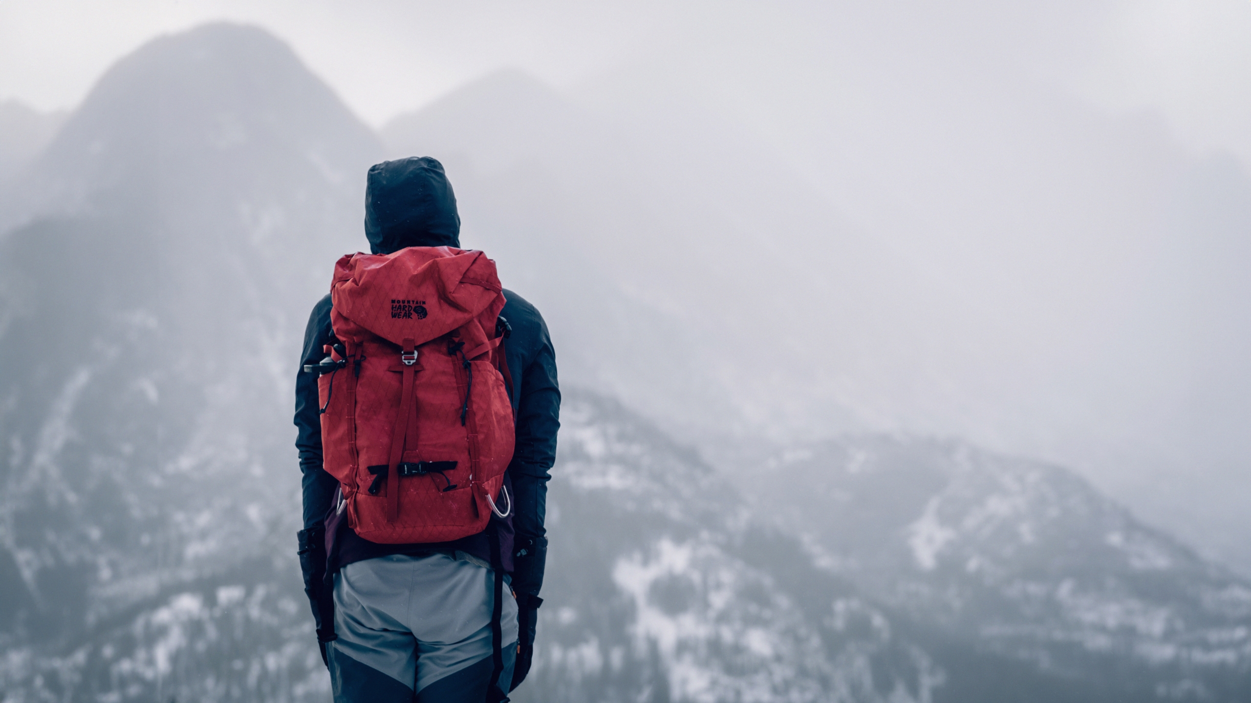 person backpacking in snowy mountains