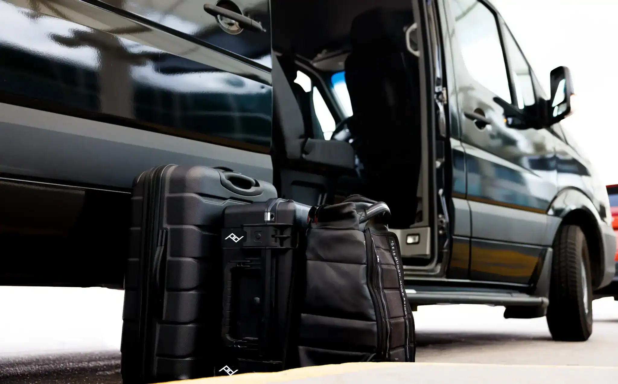 Luggage outside a group transportation van in Colorado.