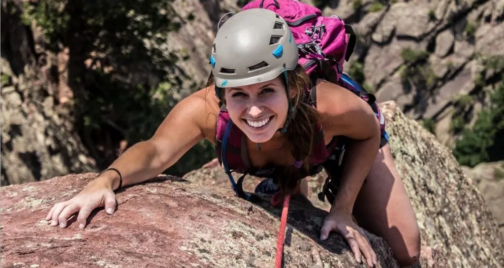Woman rock climbing during Colorado adventure.