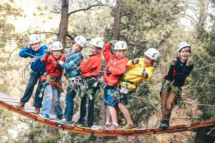 Group of people on a rustic bridge.