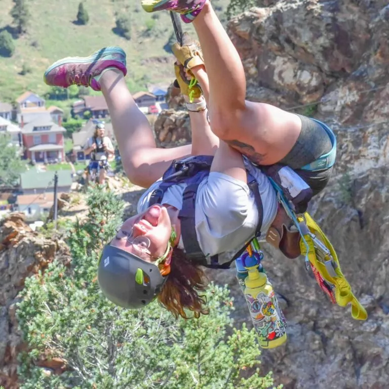 Woman upside down with her tongue out while ziplining