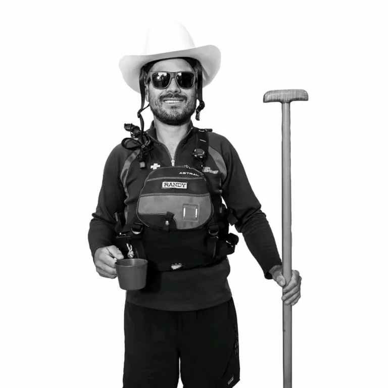 Image of a rafting guide wearing his gear and holding a coffee cup in a black and white photo