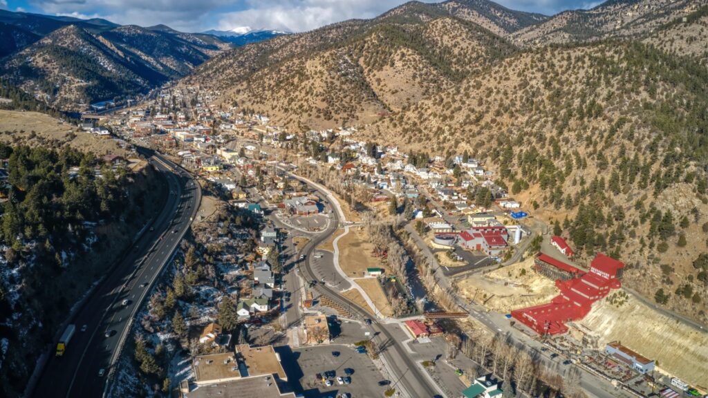 view of the town of Idaho Springs from above and Rocky Mountains in the background