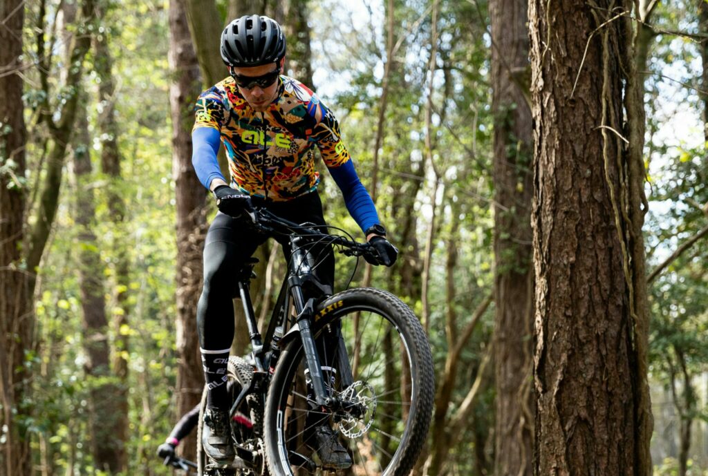 Man mountain bike riding in a Colorado forest.