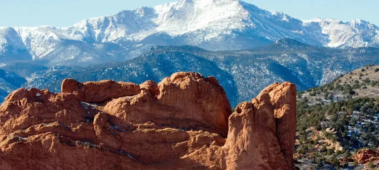 Garden of the Gods' red rock formations with Pike's Peak in the distance.