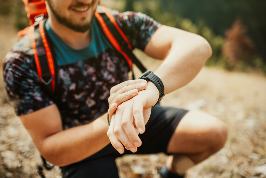 Hiking guide checking compass.