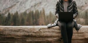 Person working on a laptop in the Colorado mountains.