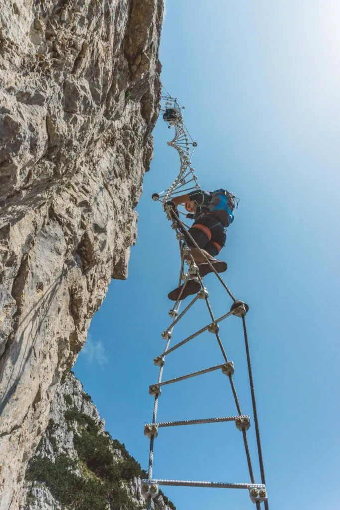 Climber on a Via Ferrata rope ladder.