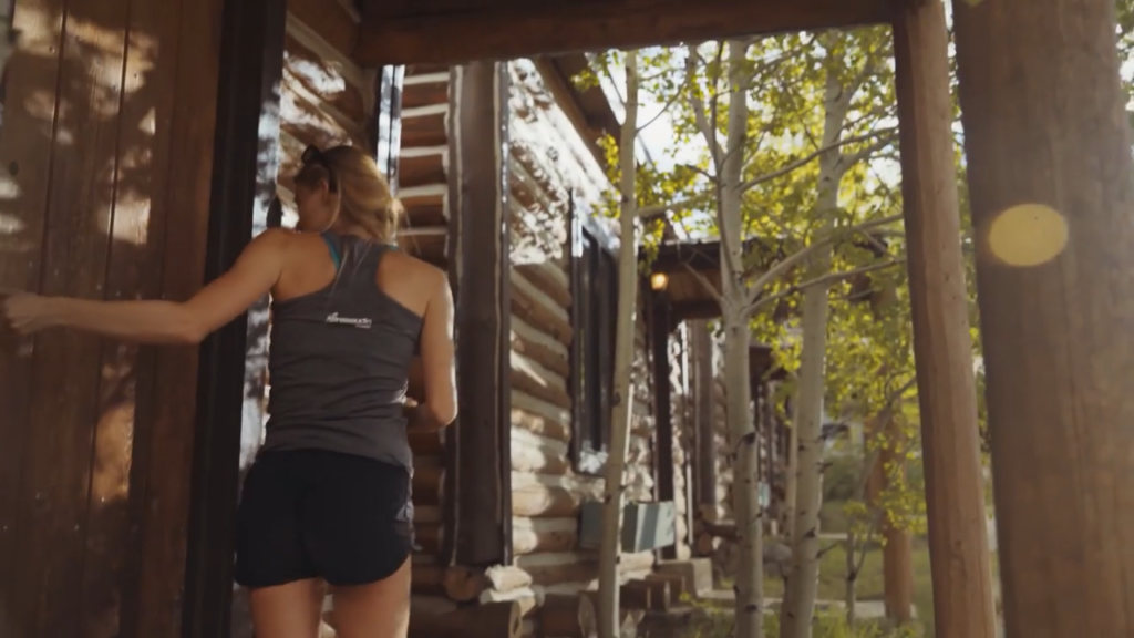 woman standing outside of cabin door