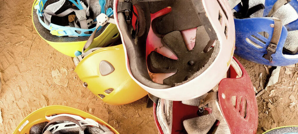 Rafting helmets on the ground.