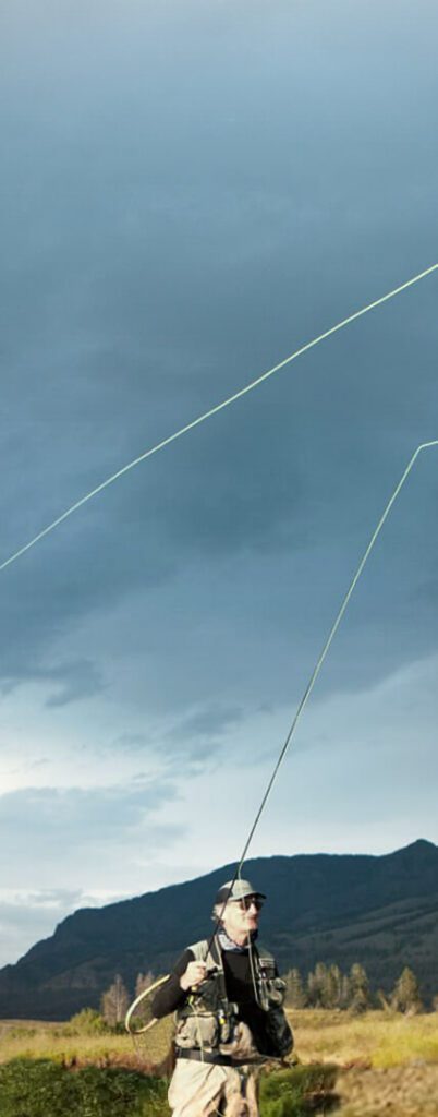 man fly fishing in colorado