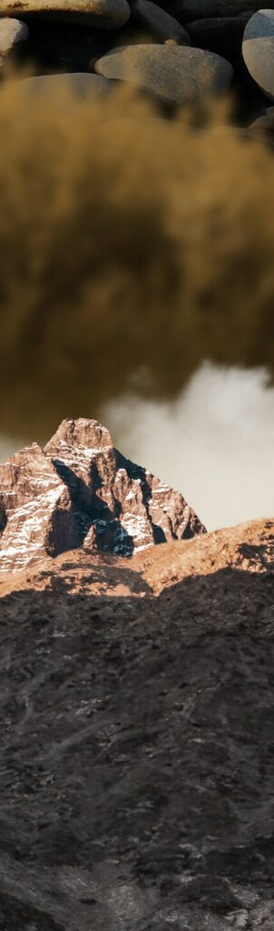 mountain rocks transition to rocks in river