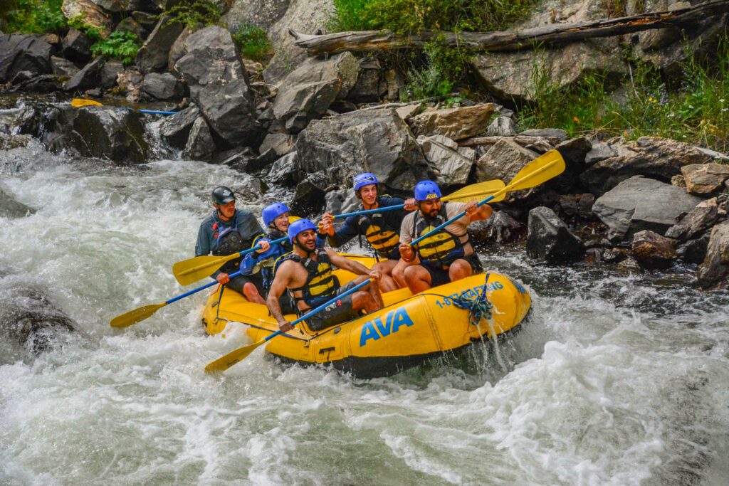 Group rafting the river in a group photo.