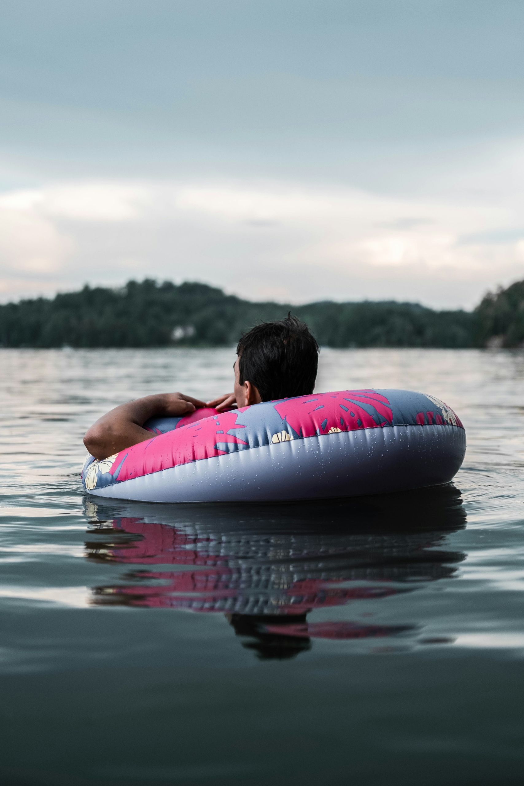 man floating in inner tube