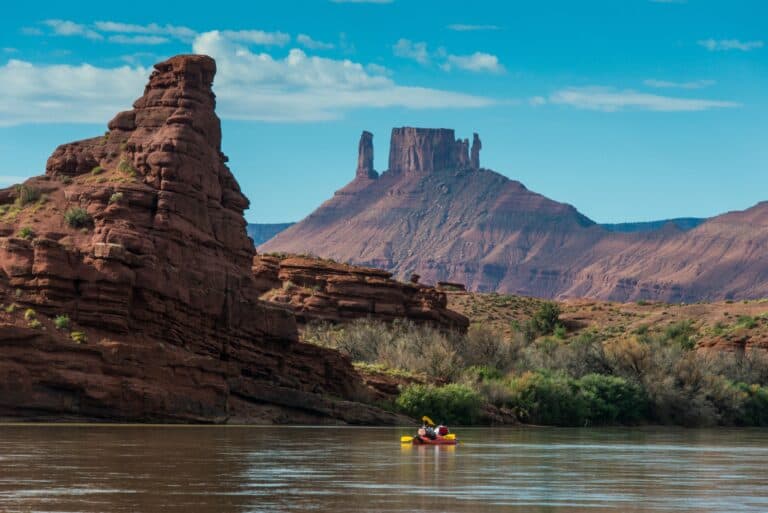 couple kayaking down the colorado river in moab