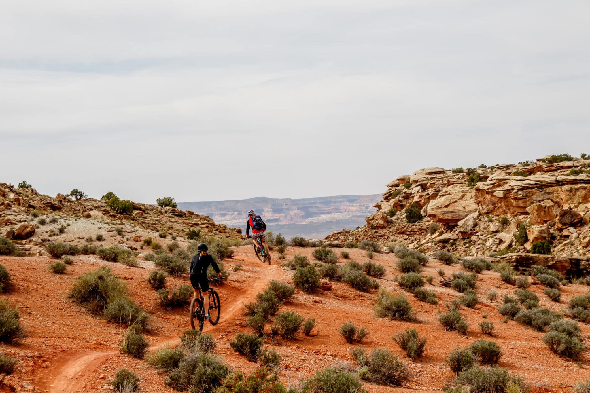 two people biking in the moab dessert