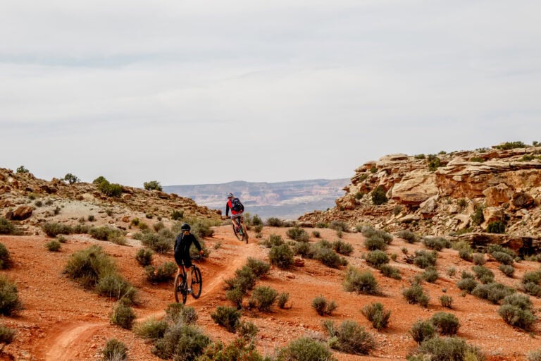 two people biking in the moab dessert